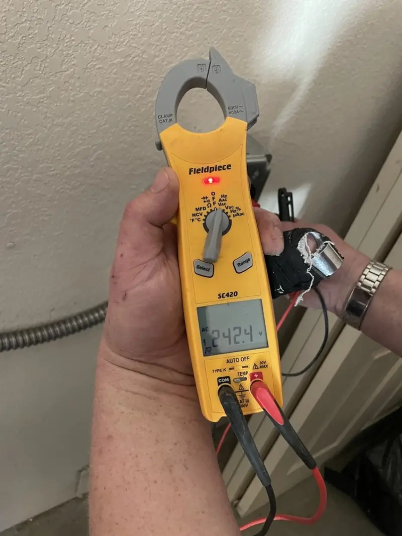 Voltage testing with clamp meter during Generator Installation in Sun Village